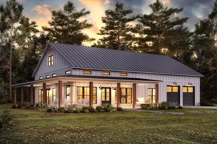 white barndominium at sunset