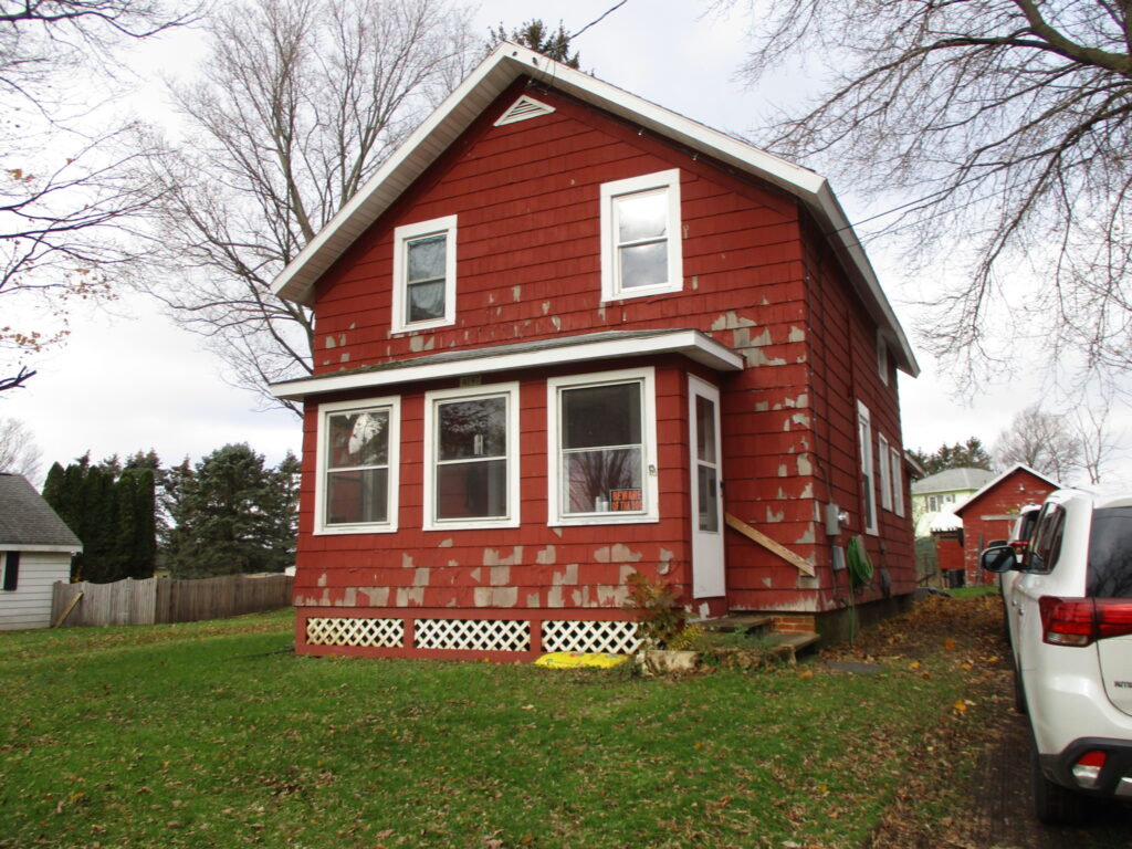 red house with peeling paint on exterior