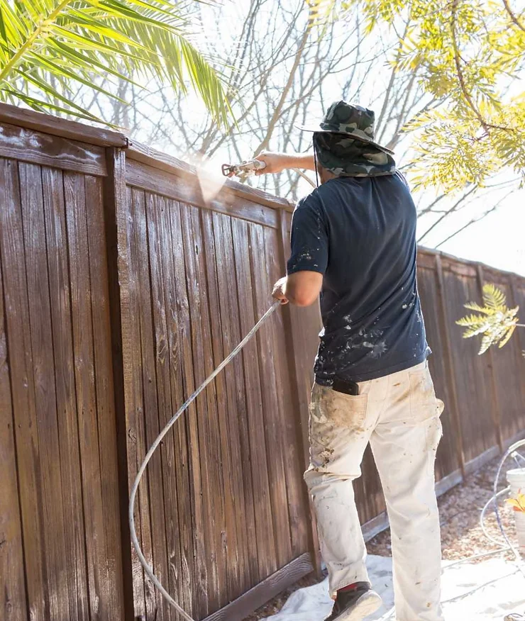 man maintaining a fence