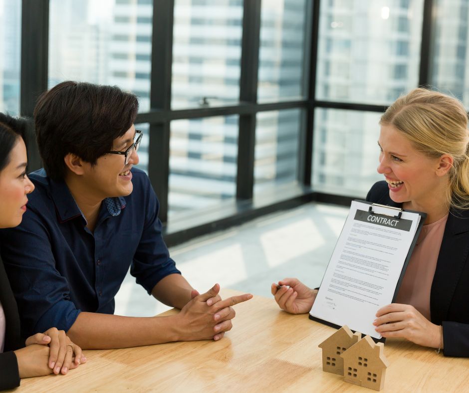 a realtor showing a contract to a couple